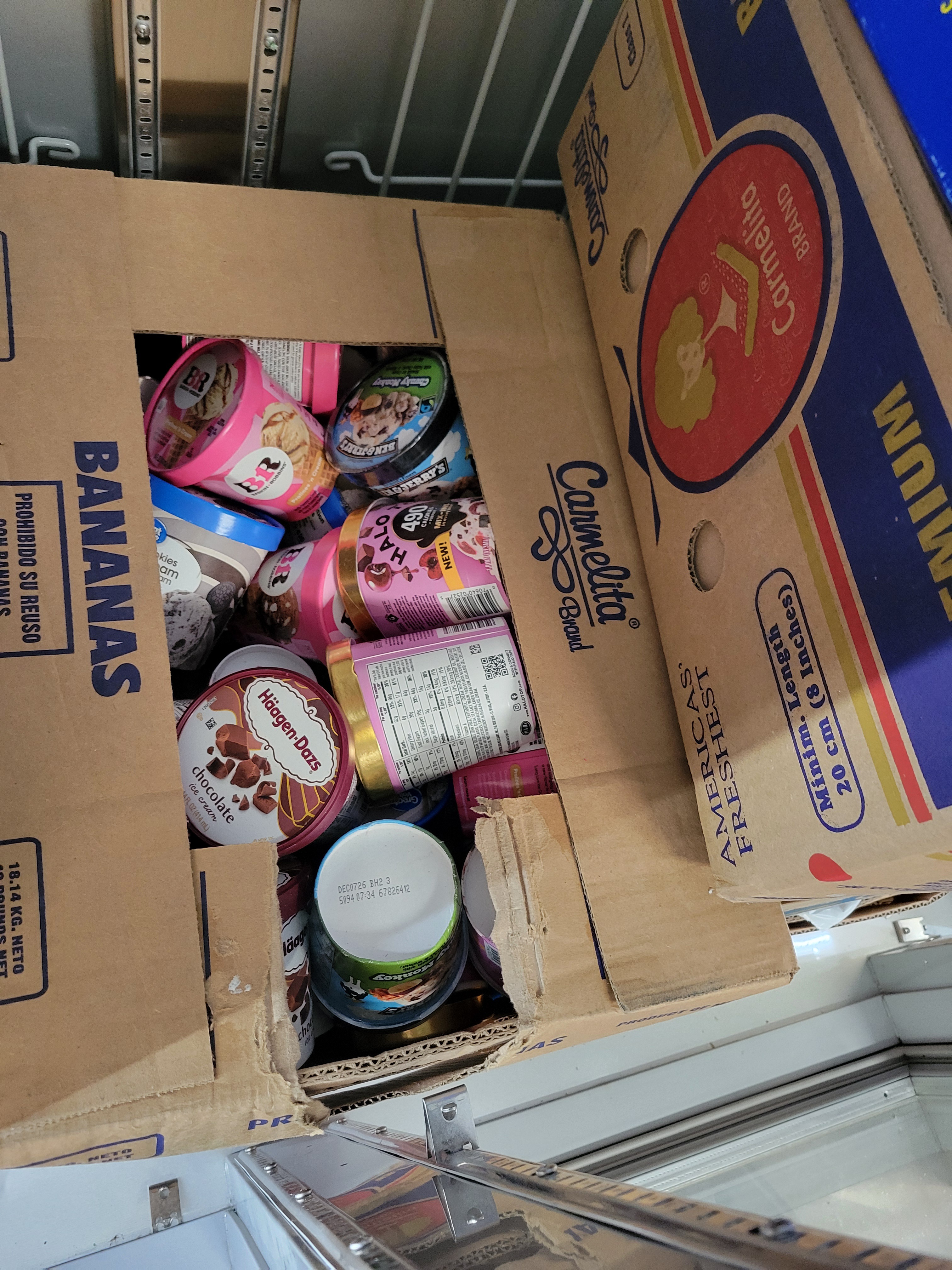 Banana boxes full of tubs of ice cream.